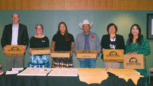 6 people standing with gift boxes